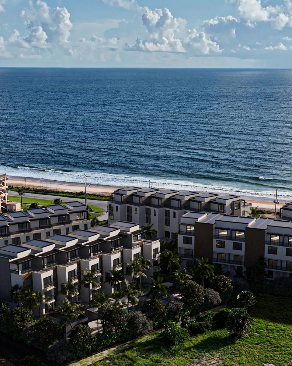 Lady on beach holding sun hat
