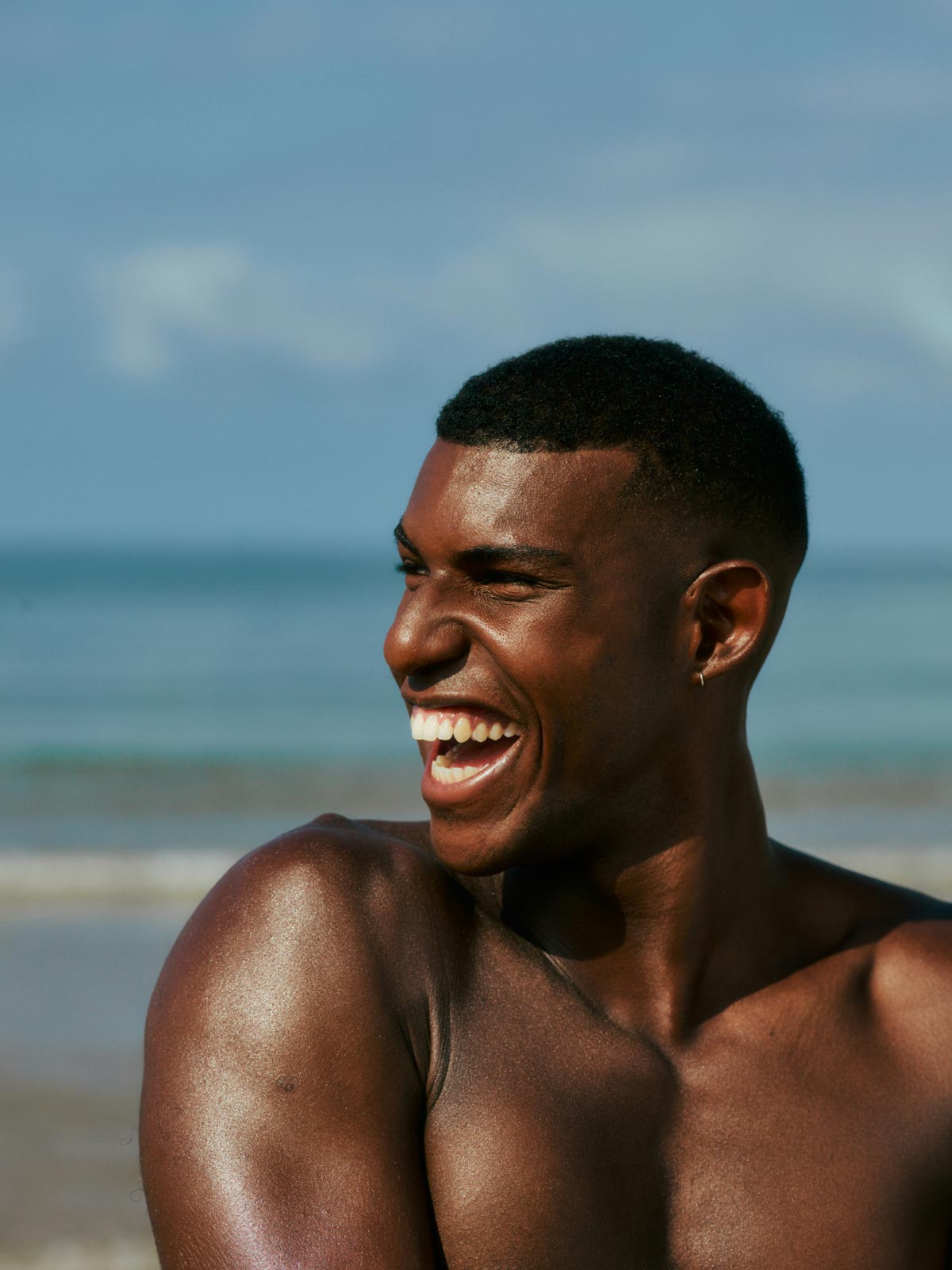 Smiling man enjoying sunshine on the beach